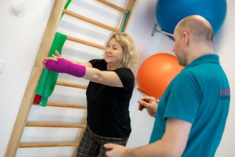 Therapeut begleitet Patientin mit Handgips bei Reha-Übung, individuelle Betreuung, Balance Aschaffenburg